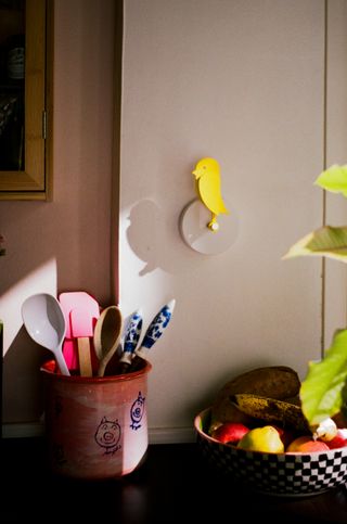 Yellow Birdie product on an off-white kitchen wall