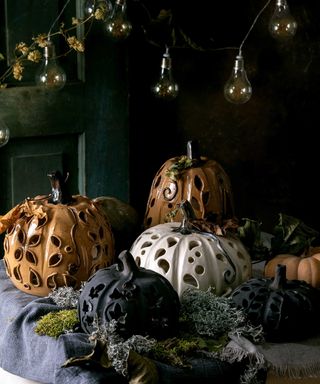 pottery pumpkin lanterns with moss and festoons