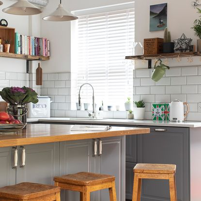 Grey kitchen makeover with white metro tiles, wood floors and green ...