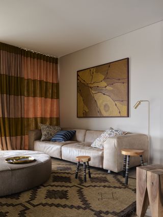 a whte living room with a beige leather couch