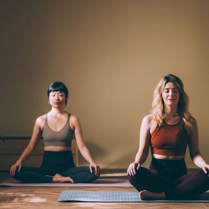 Two women doing mat Pilates