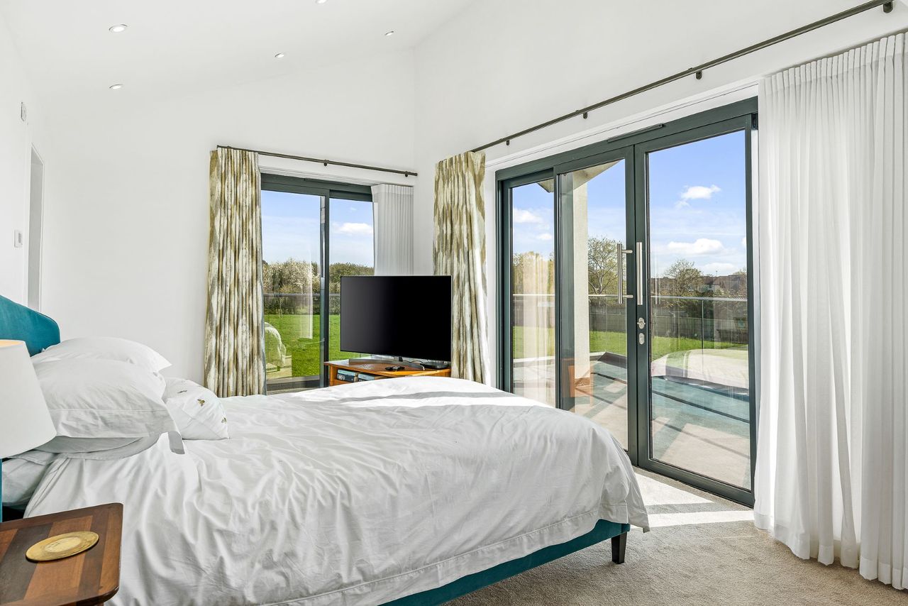 The master bedroom has an en suite shower and bifold doors that lead onto the balcony