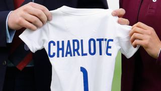 Prince William receives an England football shirt for his daughter Princess Charlotte