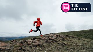 Woman running over hill in bad weather