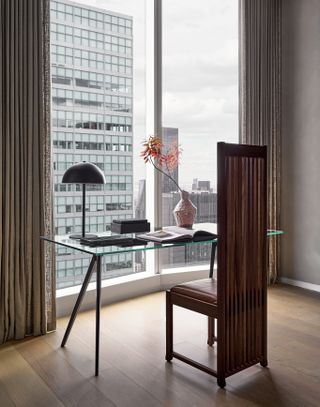 A Frank Lloyd Wright chair sits in front of a window