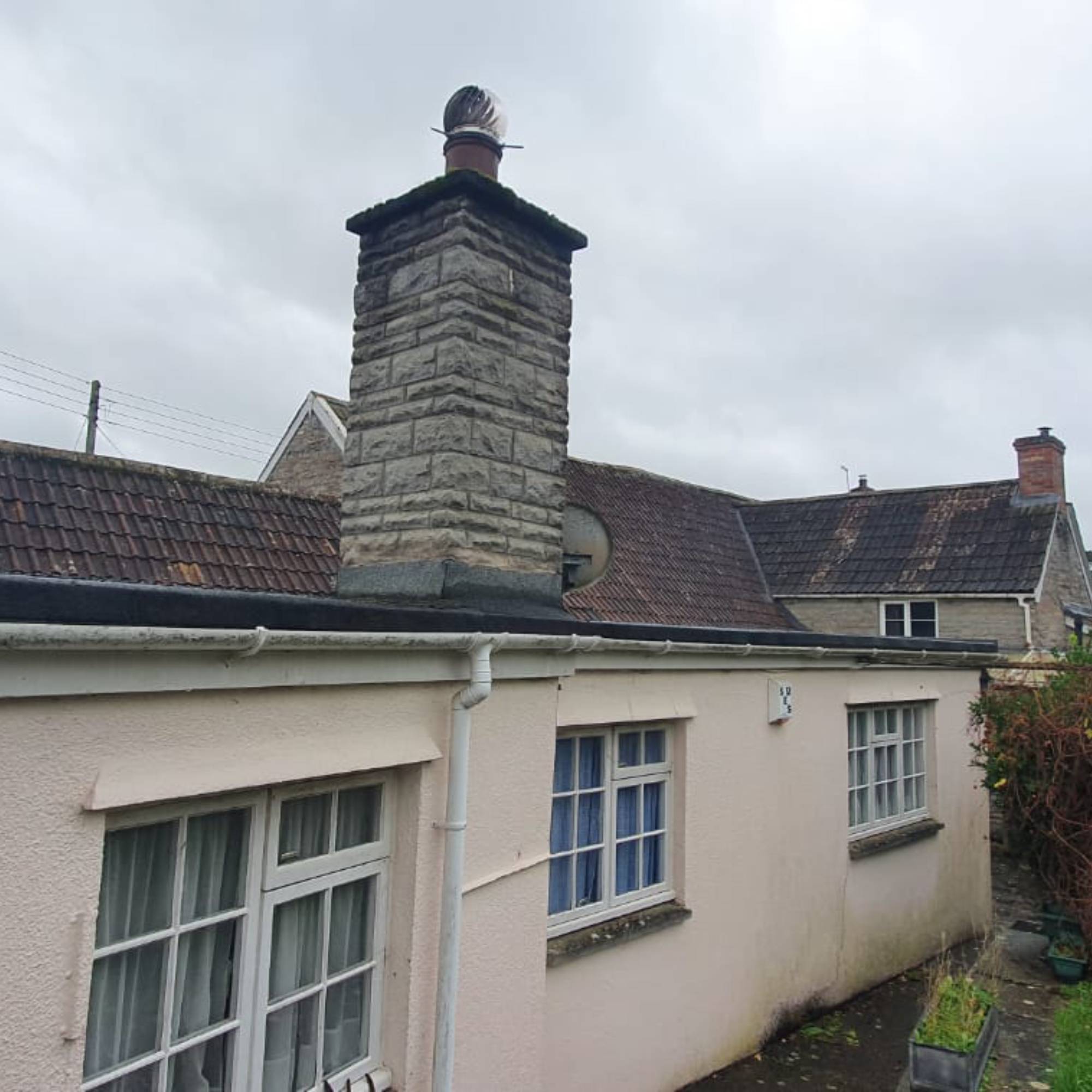 flat roof on rendered house with white windows