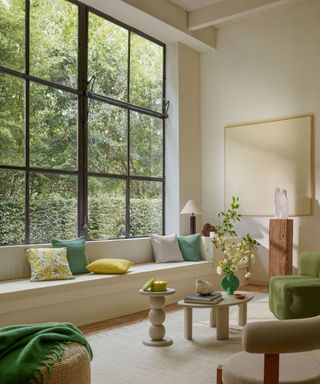 white living room with green accents and tall Crittall style windows