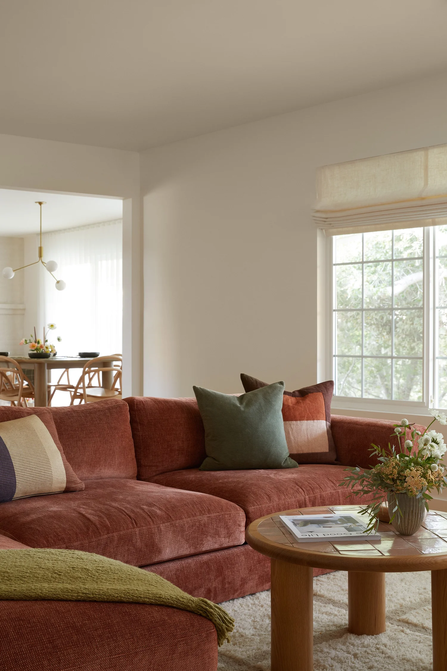 Contemporary chenille sofa in rust in a large white room