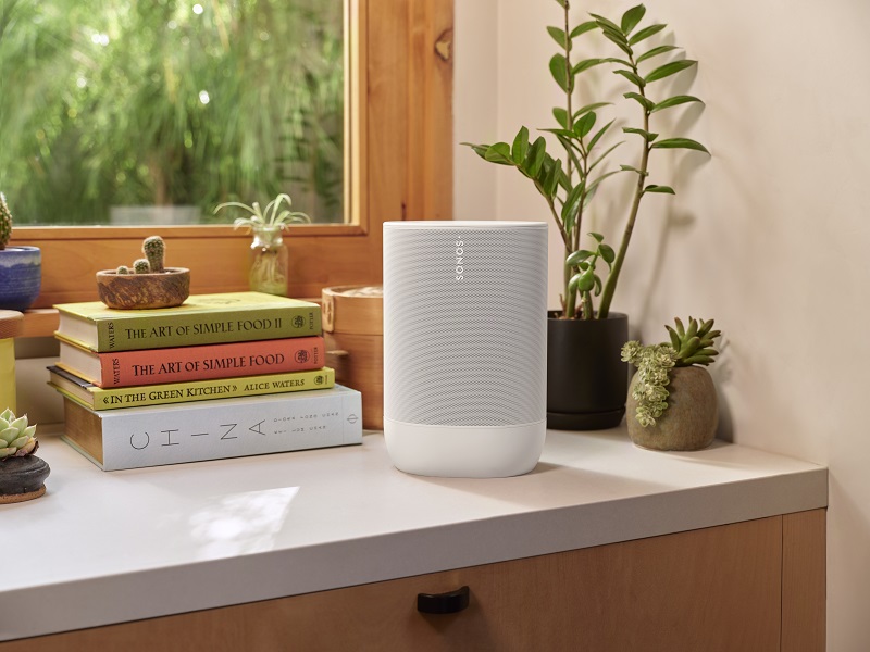 The Sonos Move 2 in a white colorway sitting on a kitchen counter.