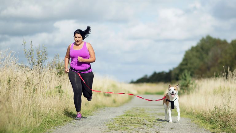 Woman out running with her dog
