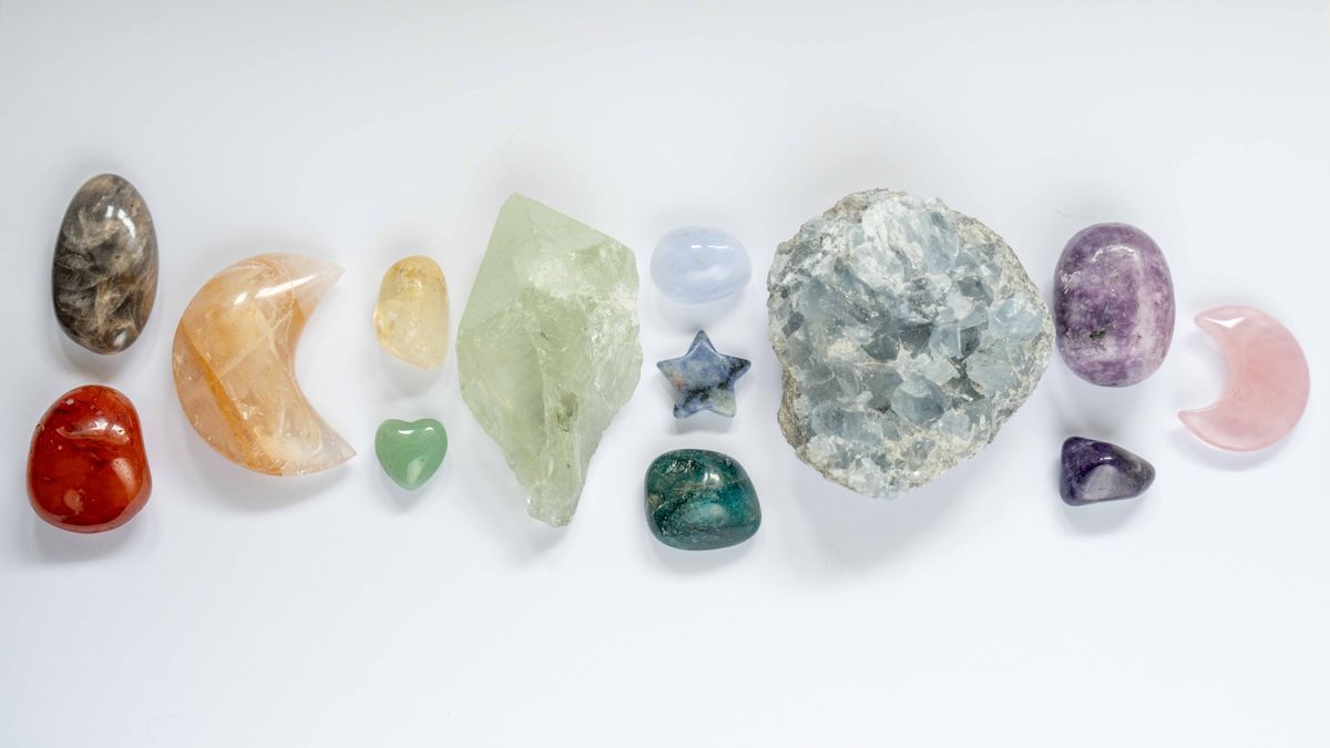 A selection of colourful crystals on a white background