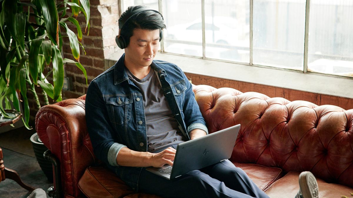 Person sitting on couch using HP x360 Chromebook