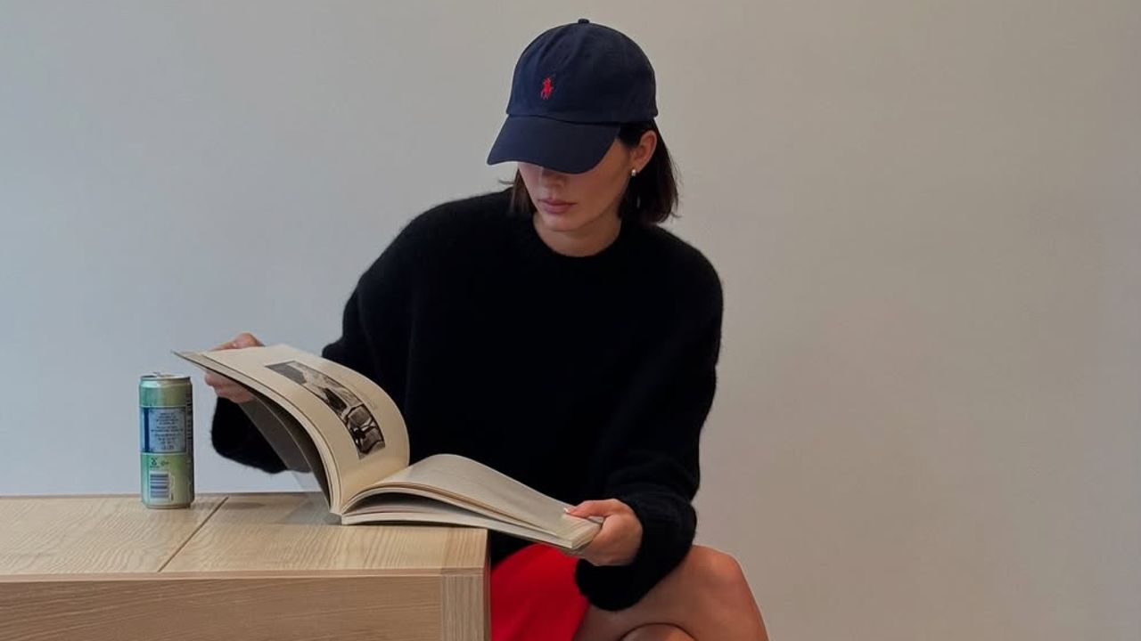 Kendall Jenner wearing a ralph lauren hat and cherry red skirt