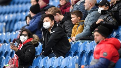 Football fans in facemasks at Turf Moor, home of Burnley