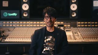 Hideo Kojima sitting in front of a mixing desk in a studio