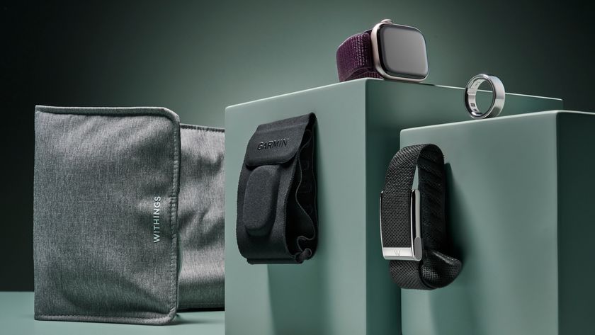 From left to right the image shows the Withings under mattress sleep tracker, Garmin Index Sleep Monitor sleep tracker, Apple Watch Series 10, the Whoop MG fitness tracker and the Oura Ring 4, all positioned on a sage green background.