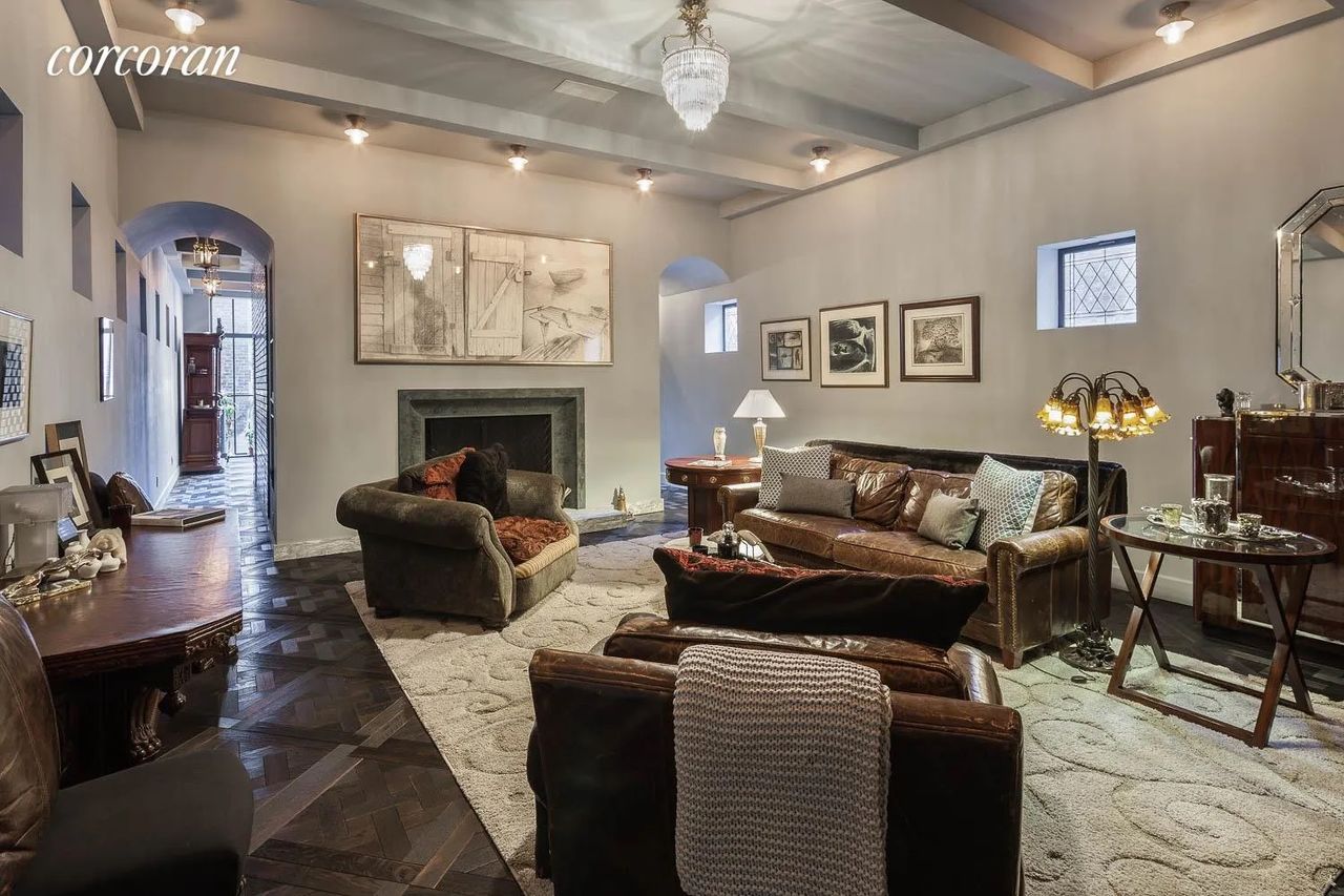 A traditional style living room with brown leather sofas 