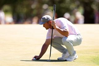 Bryson DeChambeau lines up a put during round three of the 2024 Masters