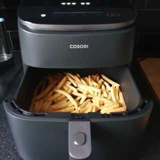 Chips in the open basket of COSORI Turbo Blaze air fryer