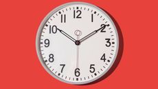 Wall clock showing 10:10 on a red background
