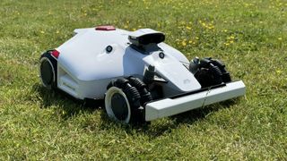 white robot mower on grass