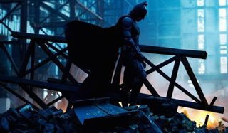 The Dark Knight Christian Bale Batman stands in the rubble