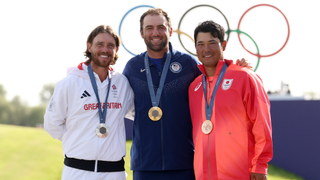 Tommy Fleetwood, Scottie Scheffler and Hideki Matsuyama pose on the podium