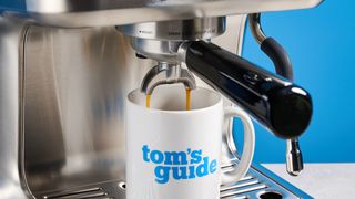 the casabrews ultra espresso machine with 20 bar pressure, a steam wand, LED screen, timer, and tamper accessories, photographed against a blue background