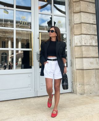 Smart shorts outfits: @mcristinastyling wears a black blazer with shorts and mary janes