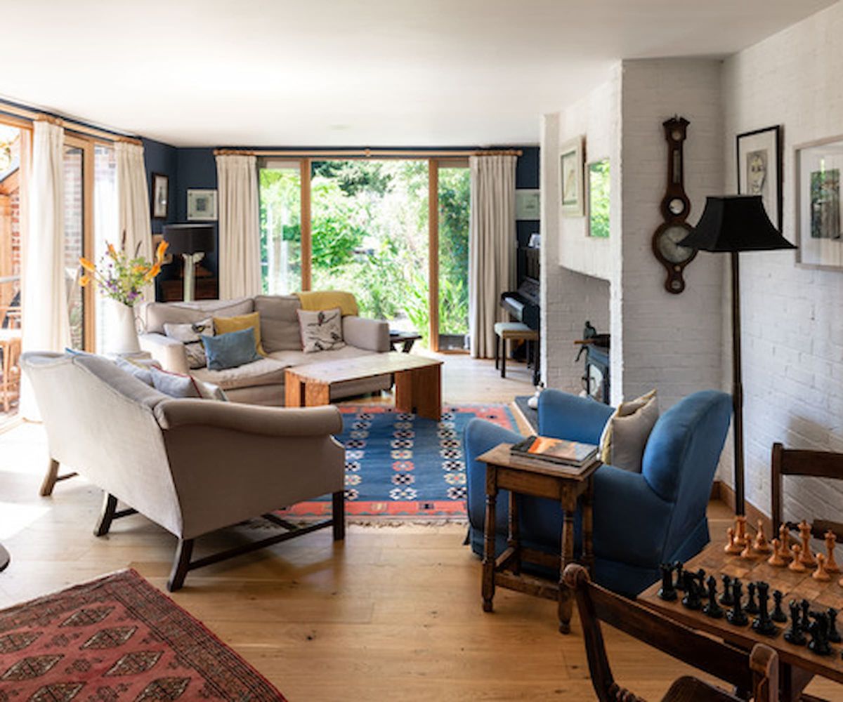 A living room connected to a conservatory and a balcony