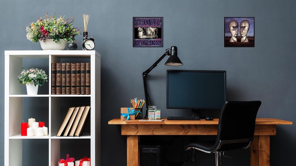 A photograph of a home office with two LPs wall-mounted above a desk