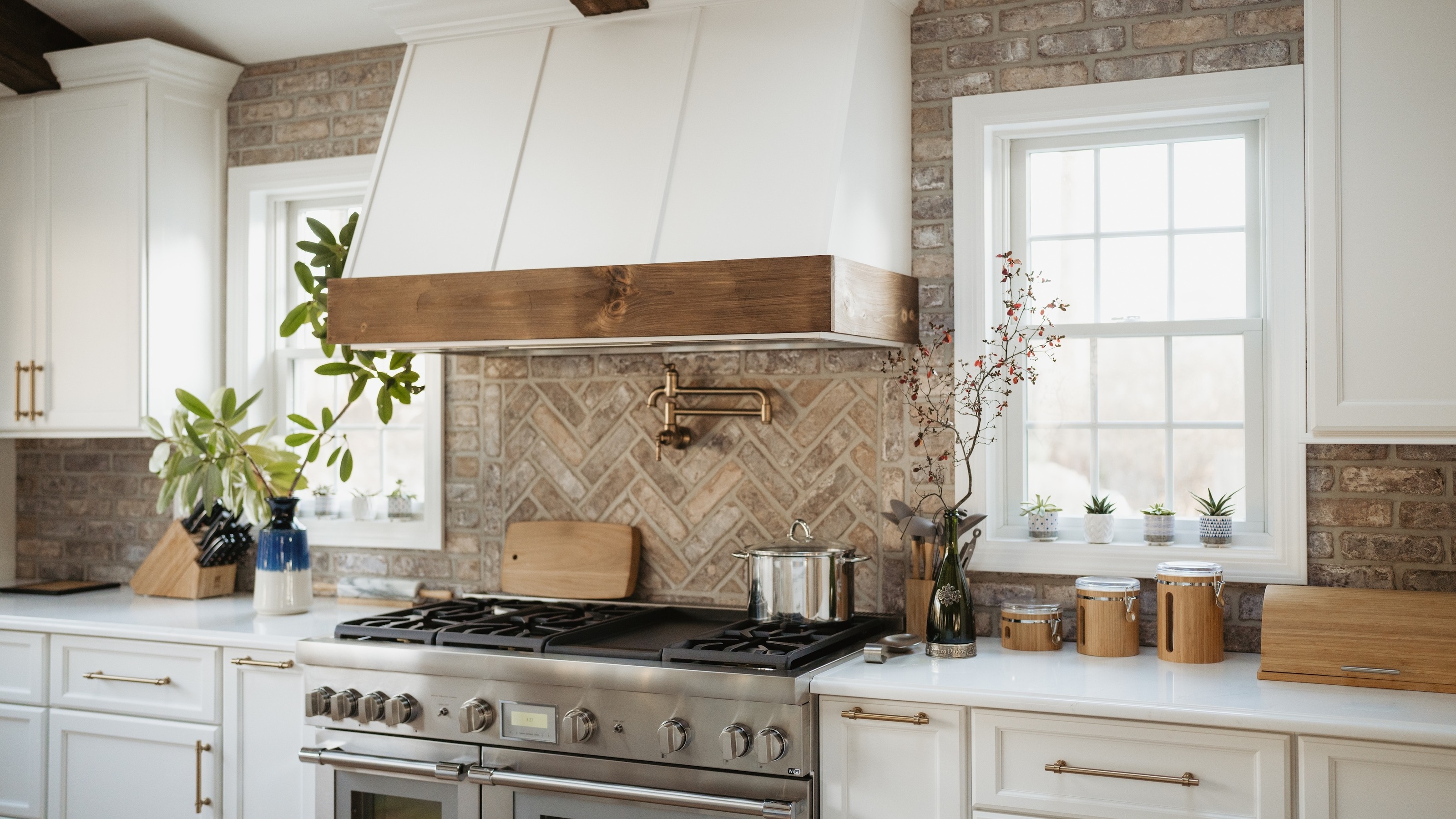 white kitchen with range cooker and chevron tiled backsplash 