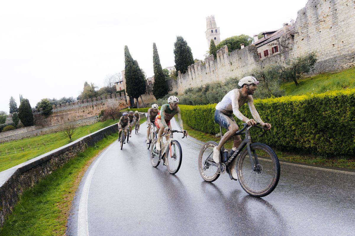 Elite men keep their eyes on the slippery course rather admiring ancient structures of Italy