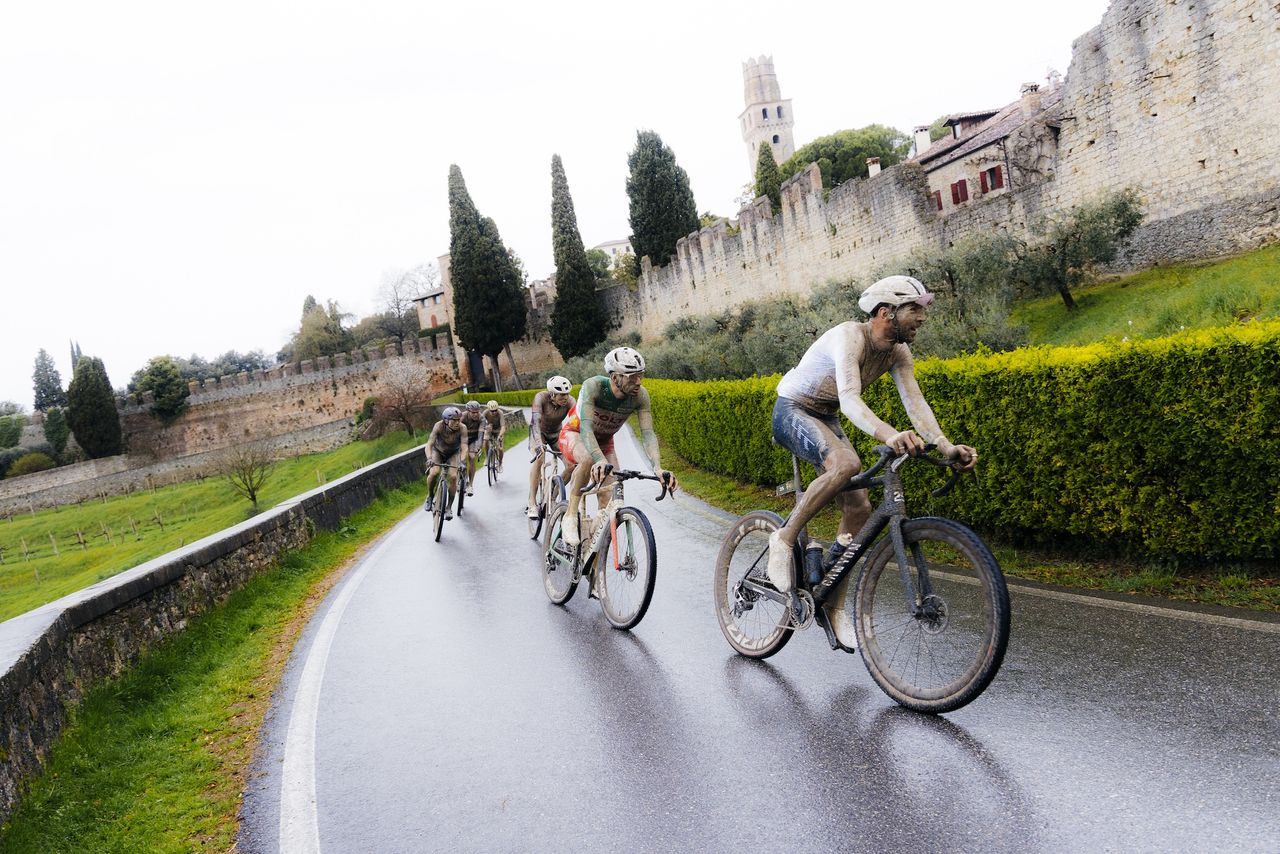 Elite men keep their eyes on the slippery course rather admiring ancient structures of Italy