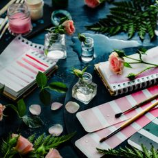 Paint brushes and color swatches with roses