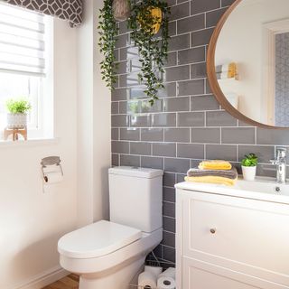 bathroom with grey tiles and white toilet