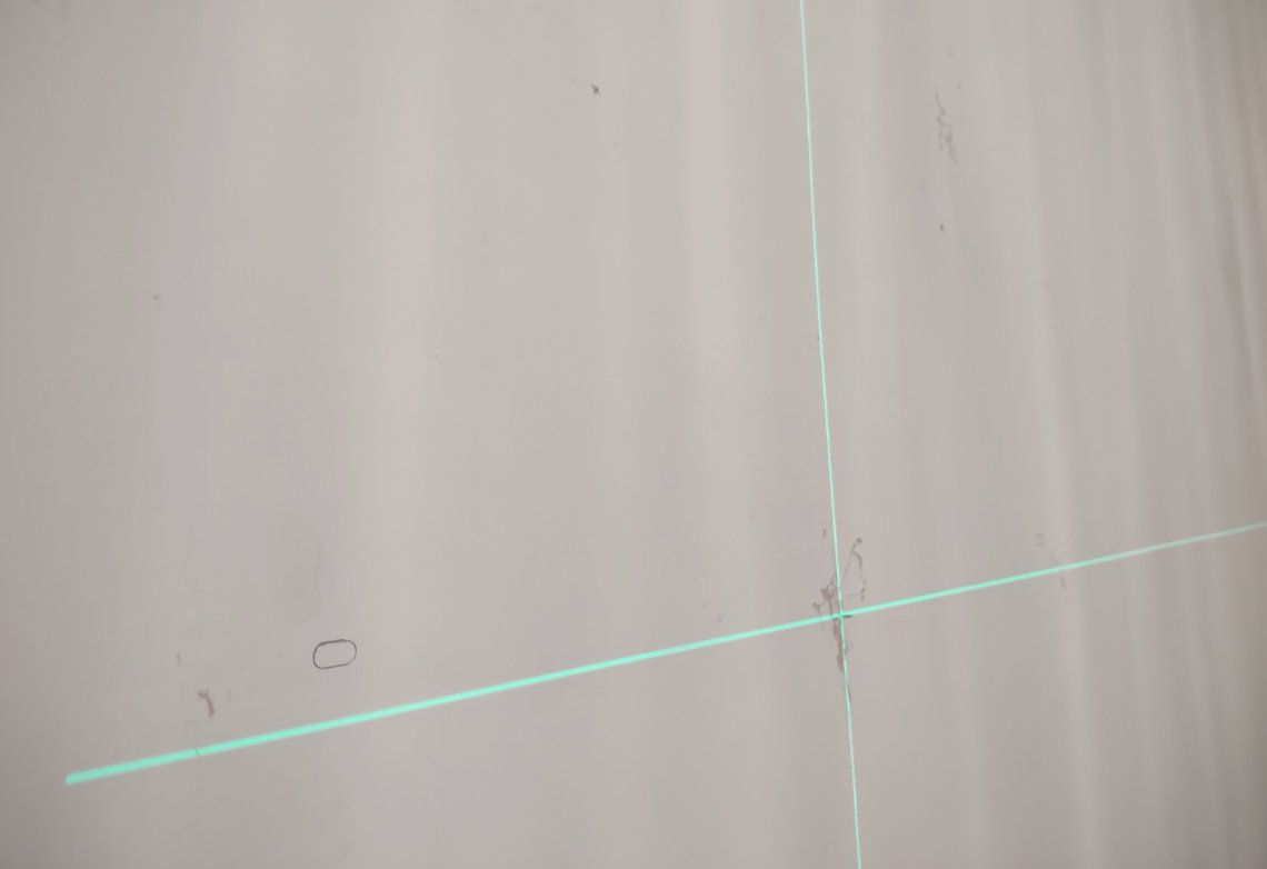 A laser being used to measure a wall