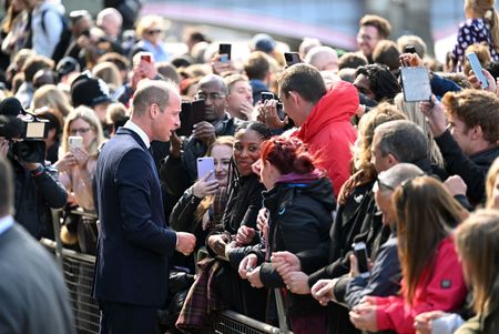 Prince William greeting crowd.