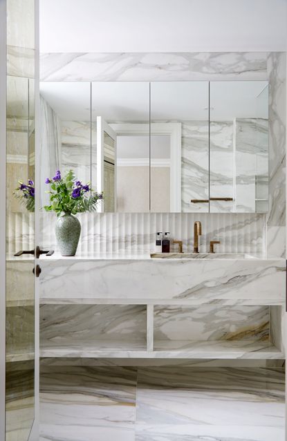 All marble bathroom with mirrored cabinet
