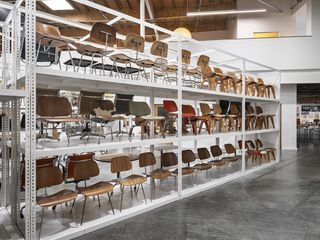 The Eames Institute of Infinite Curiosity Bay area headquarters and archive interior showing row of chair prototypes