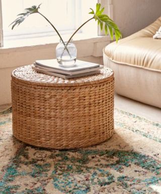 A round seagrass coffee table ottoman with lift top storage in living room