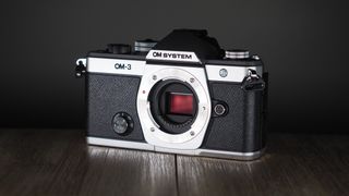 OM System OM-3 on a wooden surface