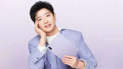 Oppo Pad Mini held by man in suit