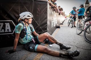 A dusty Alison Tetrick on the ground after the gravel race in Kansas