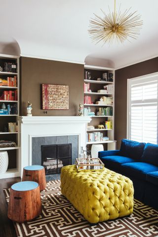 A living room with a large fireplace and bookshelves