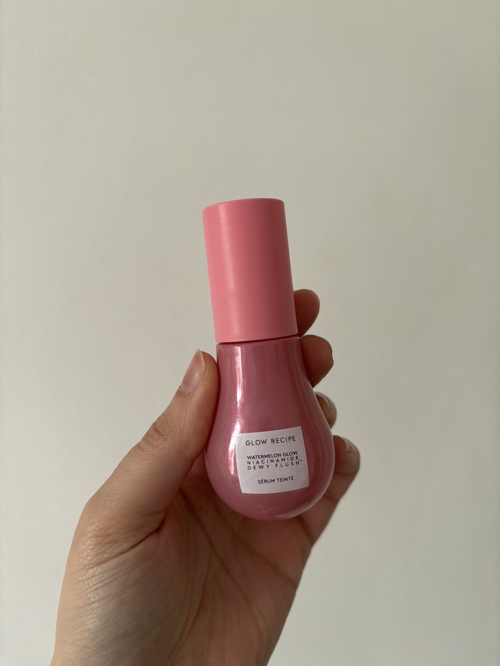 Mica Ricketts holding Glow Recipe Watermelon Glow Niacinamide Dew Drops