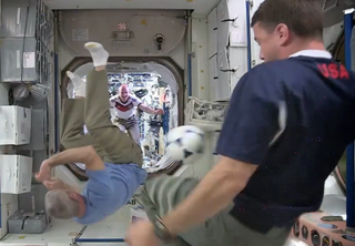 Astronaut Steve Swanson performs a bicycle kick on the International Space Station