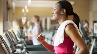 Woman reaping the treadmill benefits during a workout at the gym
