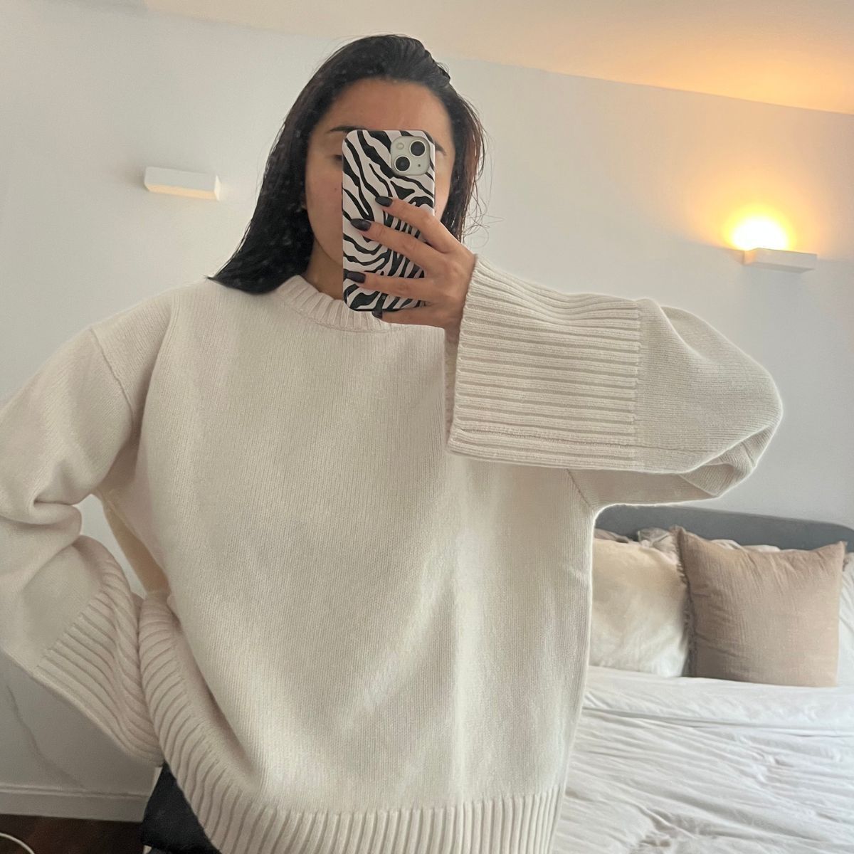 Woman wears cream jumper