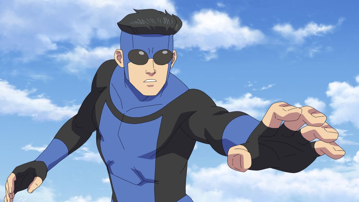 A hovering superhero in a blue-and-black costume